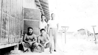 Mr. Tanaka, Interviewee Mr. Nakamura (front); Mr. Uyeda and Mr. Ono (back), Poston Relocation Camp, Block 14, 1942. (Photo courtesy Charles Nakamura.)